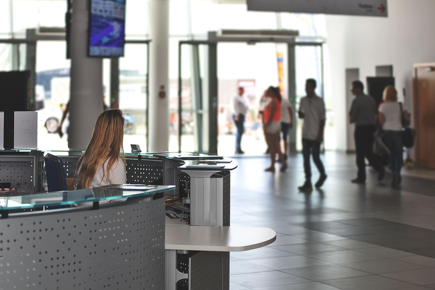 People passing through an entrance lobby where credentials are checked