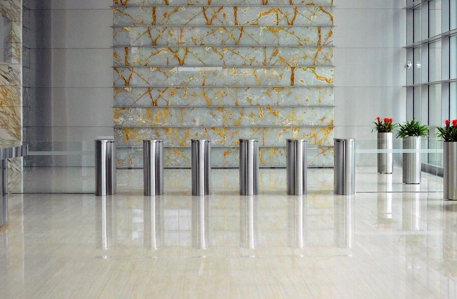 A bank of entry turnstiles in a building lobby