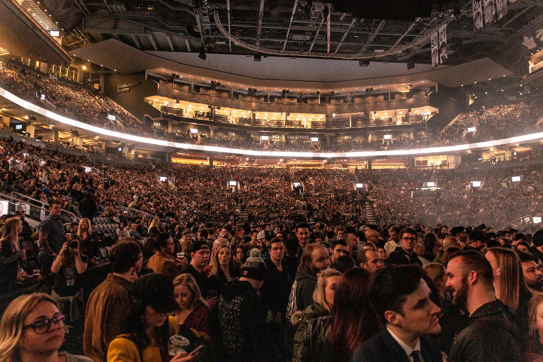 A packed arena audience seen from above during an event